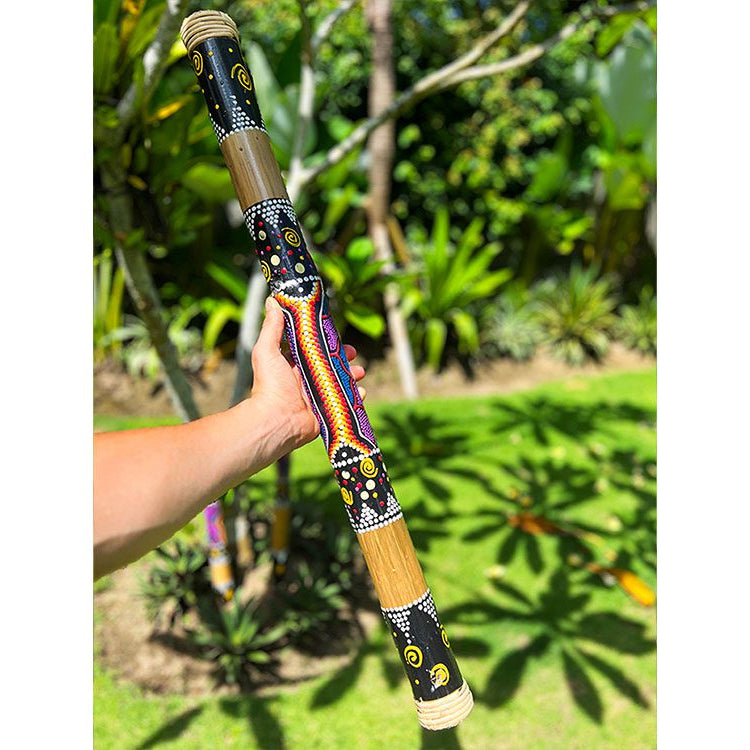 Musician tilting Rainstick to create calming rain sounds