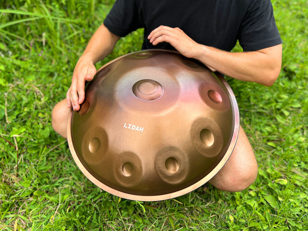 Musician playing LIDAH® Handpan in a peaceful outdoor setting